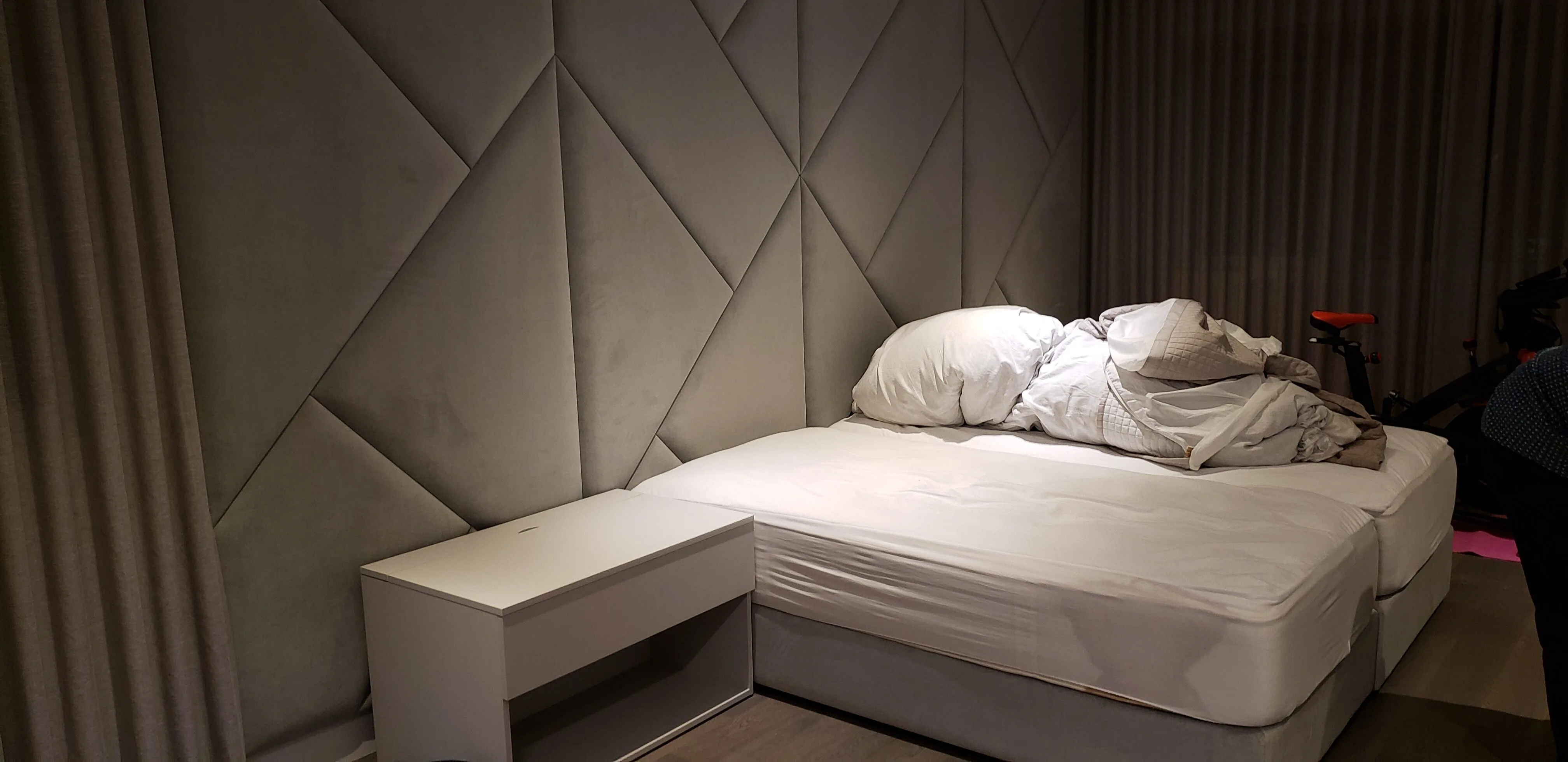 Custom upholstered headboard wall and bedside cabinet built by Meubles Ciano