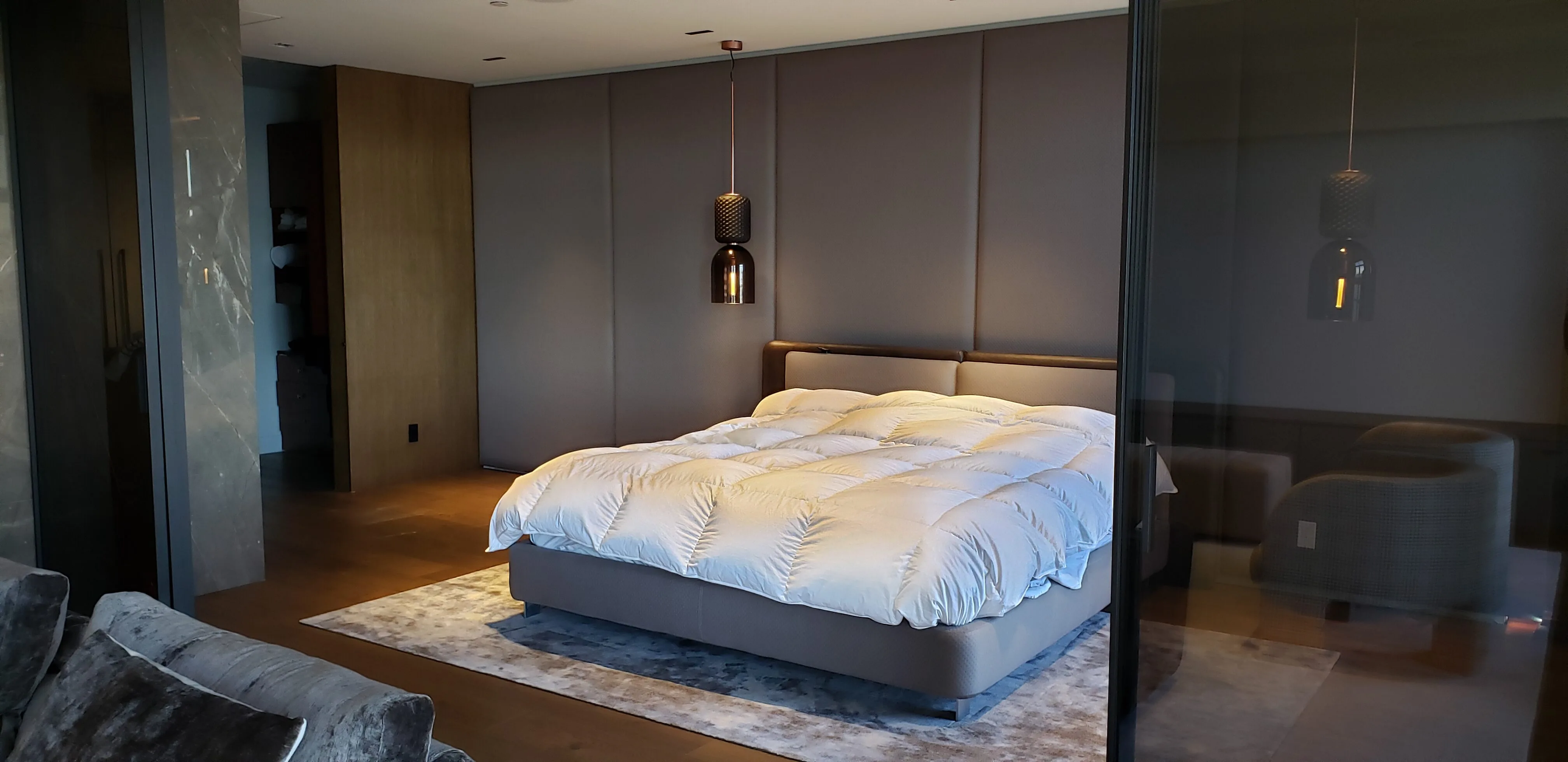 Custom wardrobe wall in a Montréal master suite by Meubles Ciano