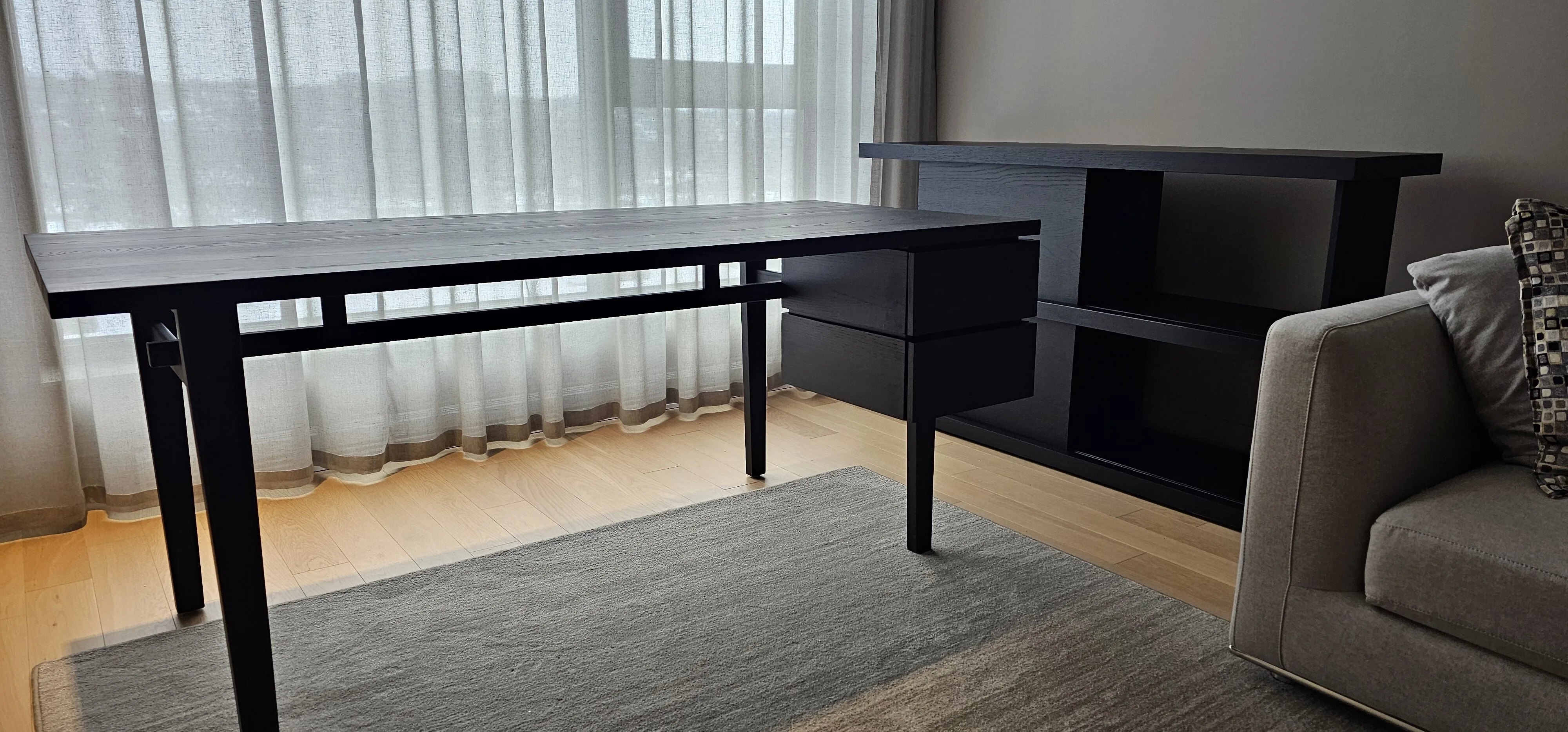 Custom blackened-oak desk and shelving for a home office by Meubles Ciano