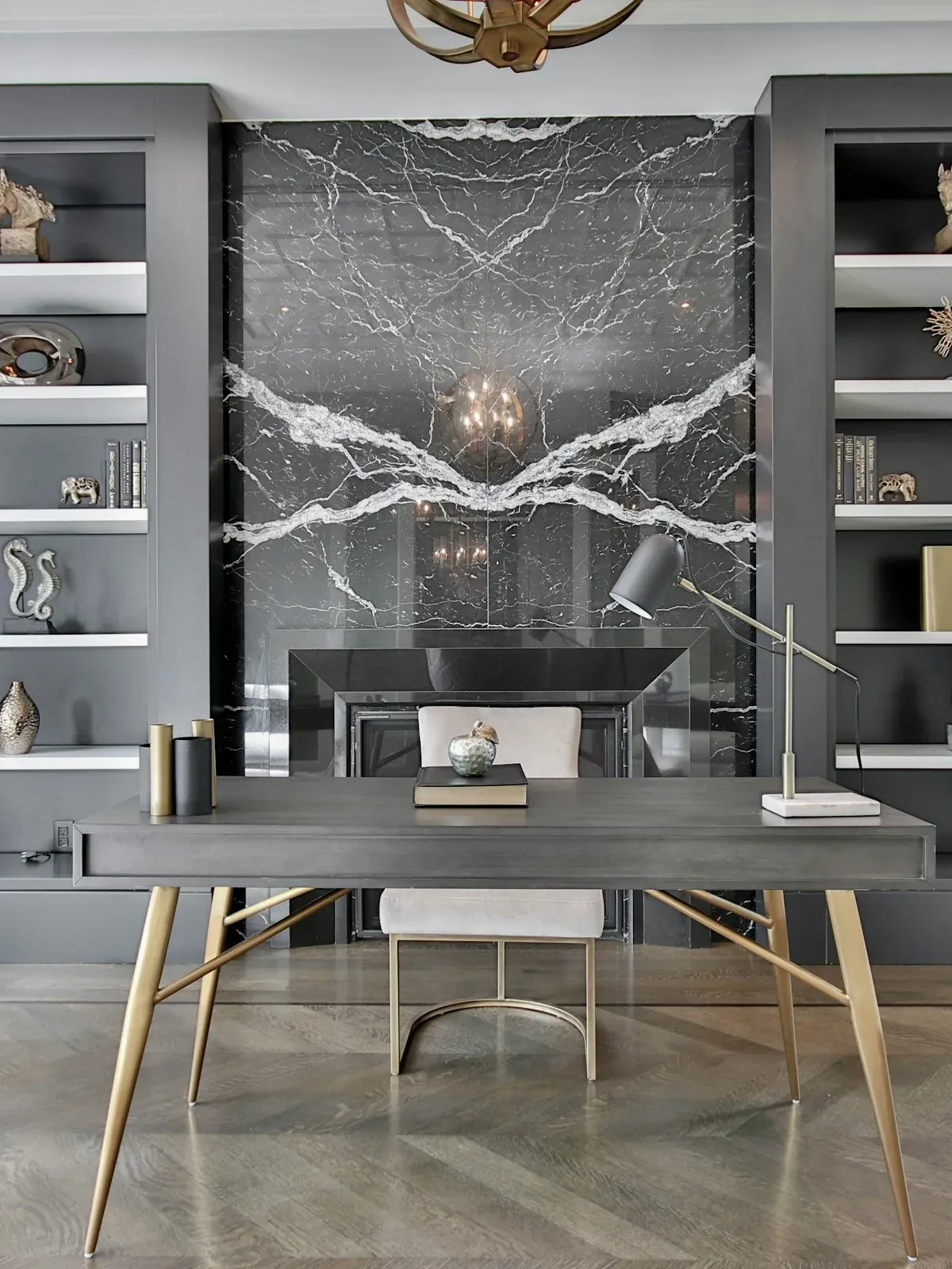 Built-in study shelving in grey flanking a marble feature panel